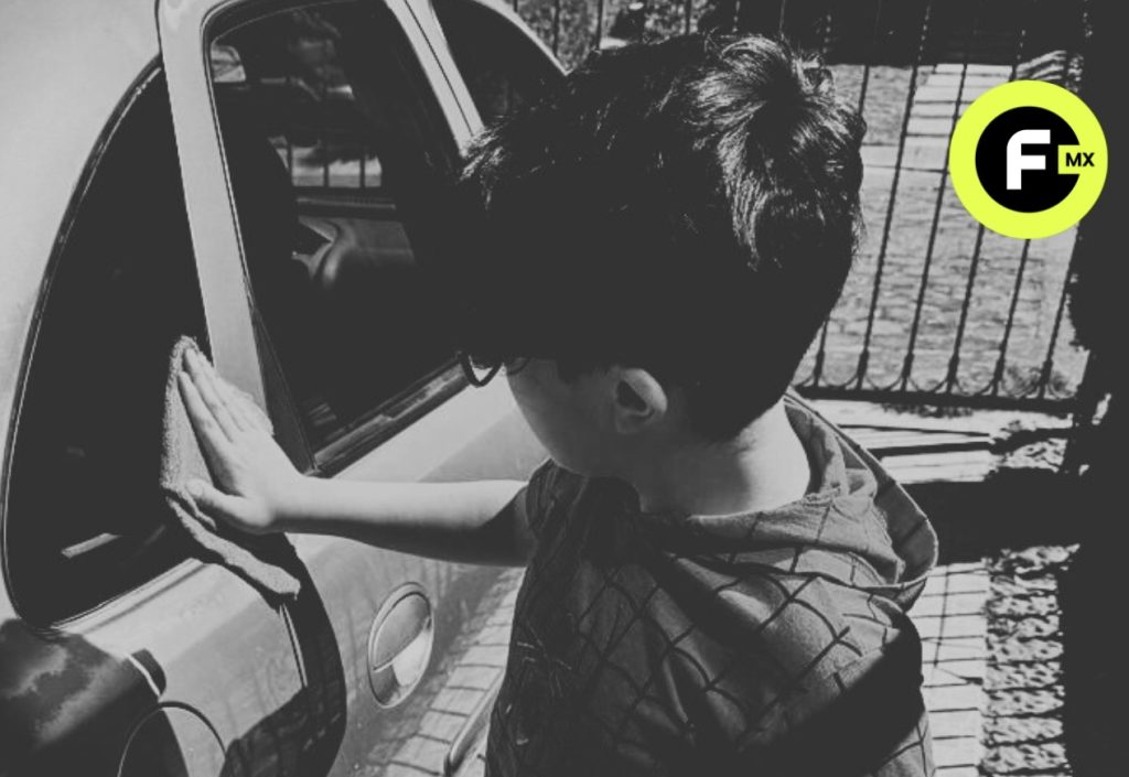 Niño limpiando un automóvil en el Estado de México como ejemplo de trabajo infantil.
